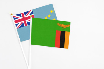 Zambia and Tuvalu stick flags on white background. High quality fabric, miniature national flag. Peaceful global concept.White floor for copy space.