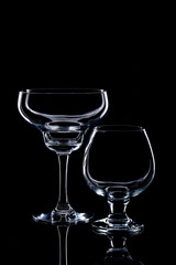 Two wine glasses silhouette isolated on black background