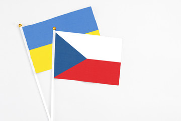 Czech Republic and Ukraine stick flags on white background. High quality fabric, miniature national flag. Peaceful global concept.White floor for copy space.