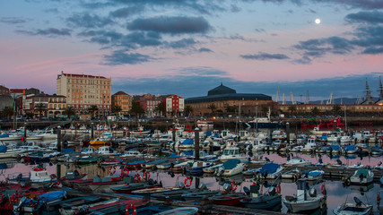 Fototapeta na wymiar Fishing Port of Ferrol by Night with Full Moon Blue and magenta Sky La Coruña Galicia