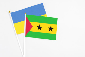 Sao Tome And Principe and Ukraine stick flags on white background. High quality fabric, miniature national flag. Peaceful global concept.White floor for copy space.