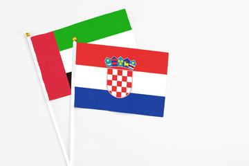 Croatia and United Arab Emirates stick flags on white background. High quality fabric, miniature national flag. Peaceful global concept.White floor for copy space.