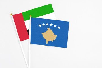 Kosovo and United Arab Emirates stick flags on white background. High quality fabric, miniature national flag. Peaceful global concept.White floor for copy space.