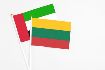 Lithuania and United Arab Emirates stick flags on white background. High quality fabric, miniature national flag. Peaceful global concept.White floor for copy space.