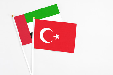 Turkey and United Arab Emirates stick flags on white background. High quality fabric, miniature national flag. Peaceful global concept.White floor for copy space.