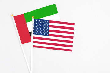 United States and United Arab Emirates stick flags on white background. High quality fabric, miniature national flag. Peaceful global concept.White floor for copy space.