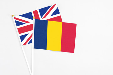 Chad and United Kingdom stick flags on white background. High quality fabric, miniature national flag. Peaceful global concept.White floor for copy space.