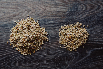 peeled sunflower seeds on a dark background