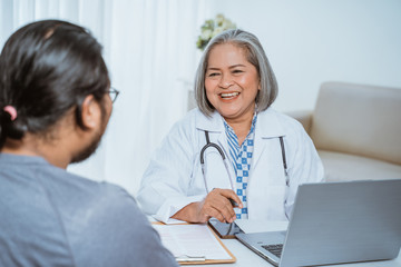 Doctor talks with the patient during the examination