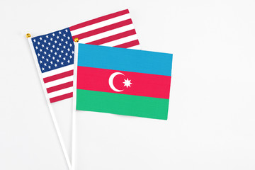 Azerbaijan and United States stick flags on white background. High quality fabric, miniature national flag. Peaceful global concept.White floor for copy space.