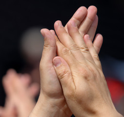 Hands clap at a rock concert