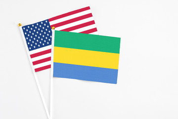 Gabon and United States stick flags on white background. High quality fabric, miniature national...