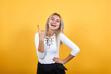 Attractive young unshaven woman in casual shirt showing finger with closed eyes isolated on white...