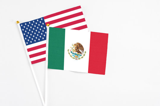 Mexico And United States Stick Flags On White Background. High Quality Fabric, Miniature National Flag. Peaceful Global Concept.White Floor For Copy Space.