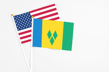 Saint Vincent And The Grenadines and United States stick flags on white background. High quality...