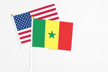 Senegal and United States stick flags on white background. High quality fabric, miniature national flag. Peaceful global concept.White floor for copy space.