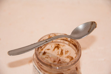 jar of honey and dipper on wooden background