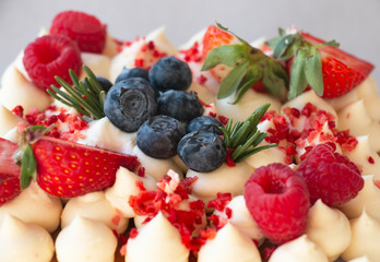sweet honey cake decorated with raspberry strawberries