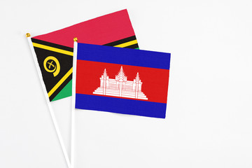Cambodia and Vanuatu stick flags on white background. High quality fabric, miniature national flag. Peaceful global concept.White floor for copy space.