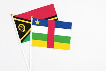 Central African Republic and Vanuatu stick flags on white background. High quality fabric, miniature national flag. Peaceful global concept.White floor for copy space.