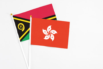 Hong Kong and Vanuatu stick flags on white background. High quality fabric, miniature national flag. Peaceful global concept.White floor for copy space.