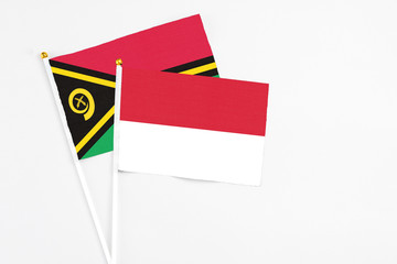 Indonesia and Vanuatu stick flags on white background. High quality fabric, miniature national...