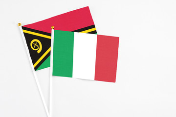 Italy and Vanuatu stick flags on white background. High quality fabric, miniature national flag. Peaceful global concept.White floor for copy space.