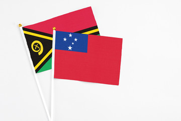 Samoa and Vanuatu stick flags on white background. High quality fabric, miniature national flag. Peaceful global concept.White floor for copy space.