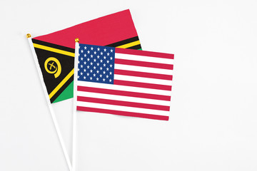 United States and Vanuatu stick flags on white background. High quality fabric, miniature national flag. Peaceful global concept.White floor for copy space.