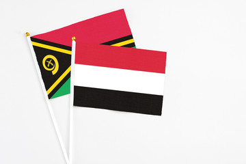 Yemen and Vanuatu stick flags on white background. High quality fabric, miniature national flag. Peaceful global concept.White floor for copy space.