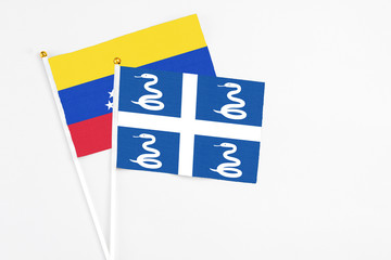 Martinique and Venezuela stick flags on white background. High quality fabric, miniature national flag. Peaceful global concept.White floor for copy space.