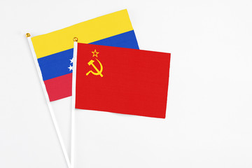 Soviet Union and Venezuela stick flags on white background. High quality fabric, miniature national flag. Peaceful global concept.White floor for copy space.