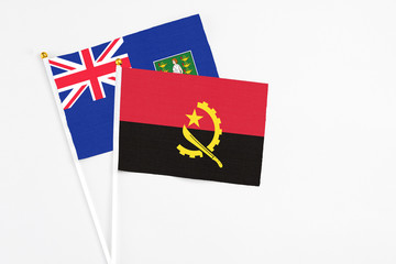 Angola and British Virgin Islands stick flags on white background. High quality fabric, miniature national flag. Peaceful global concept.White floor for copy space.
