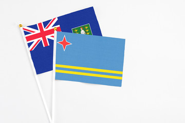 Aruba and British Virgin Islands stick flags on white background. High quality fabric, miniature national flag. Peaceful global concept.White floor for copy space.