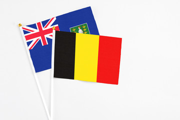 Belgium and British Virgin Islands stick flags on white background. High quality fabric, miniature national flag. Peaceful global concept.White floor for copy space.