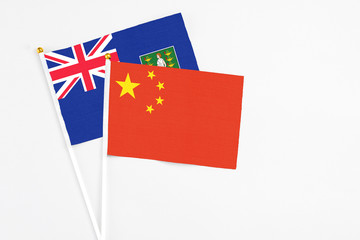 China and British Virgin Islands stick flags on white background. High quality fabric, miniature national flag. Peaceful global concept.White floor for copy space.