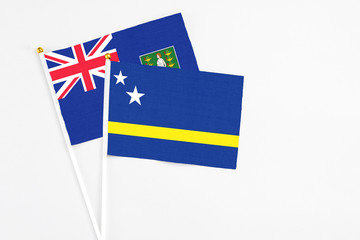 Curacao and British Virgin Islands stick flags on white background. High quality fabric, miniature national flag. Peaceful global concept.White floor for copy space.