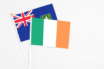 Ireland and British Virgin Islands stick flags on white background. High quality fabric, miniature national flag. Peaceful global concept.White floor for copy space.