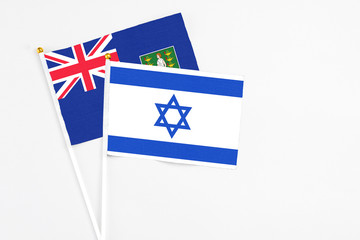 Fototapeta premium Israel and British Virgin Islands stick flags on white background. High quality fabric, miniature national flag. Peaceful global concept.White floor for copy space.