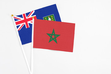Morocco and British Virgin Islands stick flags on white background. High quality fabric, miniature national flag. Peaceful global concept.White floor for copy space.