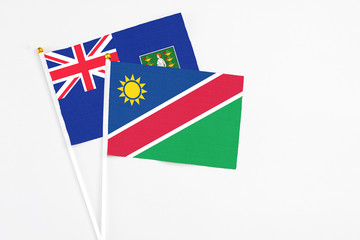 Namibia and British Virgin Islands stick flags on white background. High quality fabric, miniature national flag. Peaceful global concept.White floor for copy space.