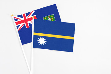 Nauru and British Virgin Islands stick flags on white background. High quality fabric, miniature national flag. Peaceful global concept.White floor for copy space.