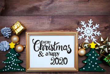 English Calligraphy Merry Christmas And Happy 2020. Red Christmas Decoration Like Ball, Frame, Tree And Snowflake. Wooden Background
