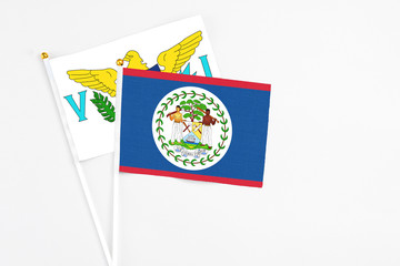 Belize and United States Virgin Islands stick flags on white background. High quality fabric, miniature national flag. Peaceful global concept.White floor for copy space.