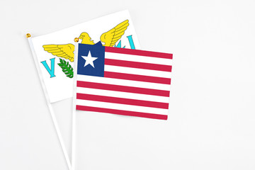 Liberia and United States Virgin Islands stick flags on white background. High quality fabric, miniature national flag. Peaceful global concept.White floor for copy space.