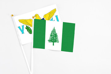 Norfolk Island and United States Virgin Islands stick flags on white background. High quality fabric, miniature national flag. Peaceful global concept.White floor for copy space.