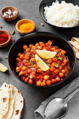 Traditional Indian dish chickpea chana masala with rice and flatbread.