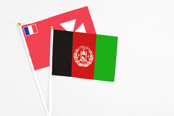 Afghanistan and Wallis And Futuna stick flags on white background. High quality fabric, miniature national flag. Peaceful global concept.White floor for copy space.