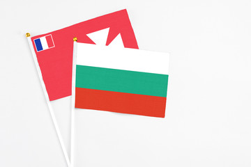 Bulgaria and Wallis And Futuna stick flags on white background. High quality fabric, miniature national flag. Peaceful global concept.White floor for copy space.