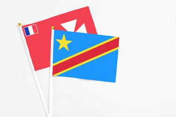 Congo and Wallis And Futuna stick flags on white background. High quality fabric, miniature national flag. Peaceful global concept.White floor for copy space.